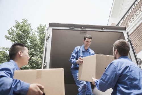 Furniture pick-up team handling bulky items in a Vauxhall flat