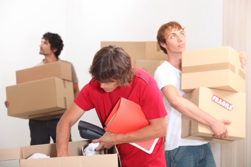 Removal crew loading household items from a London apartment