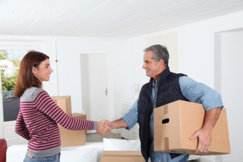 Worker wearing PPE while handling furniture for a man with a van job
