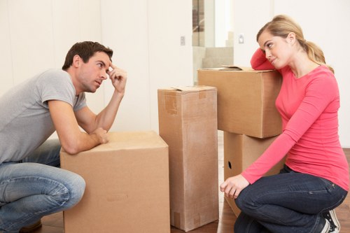 Professional moving team loading household items into a van